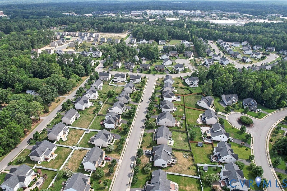 Residential development featuring multiple single-family homes with gray roofs and varied architectural styles