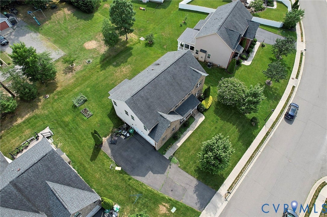 Two-story residence with a gray shingle roof and a two-car driveway