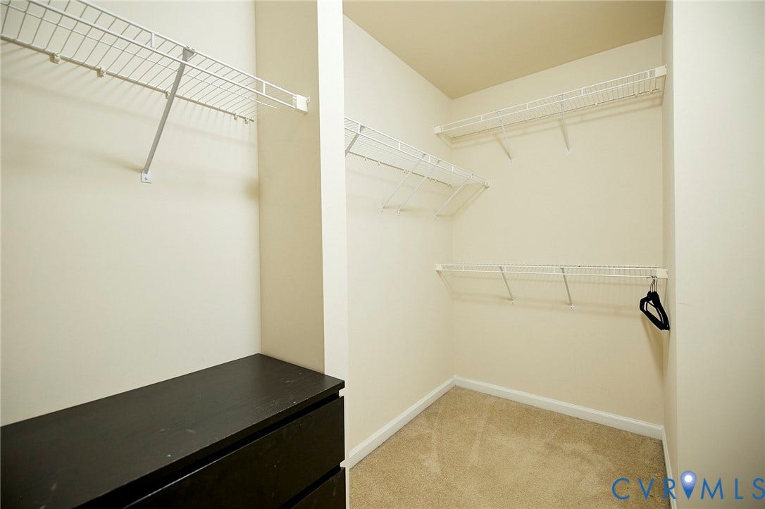 Built-in shelving, wire racks, and a carpeted floor