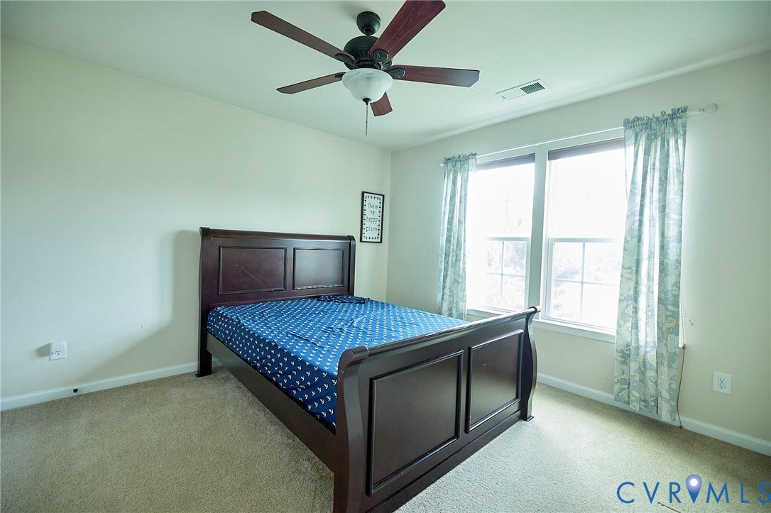 Carpeted flooring, recessed window, ceiling fan with integrated lighting
