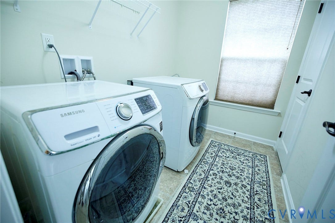 Laundry area featuring light-toned walls and vinyl flooring