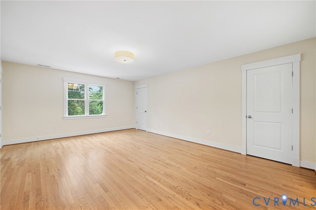 Hardwood flooring, painted walls, white trim, recessed window, flush mount lighting