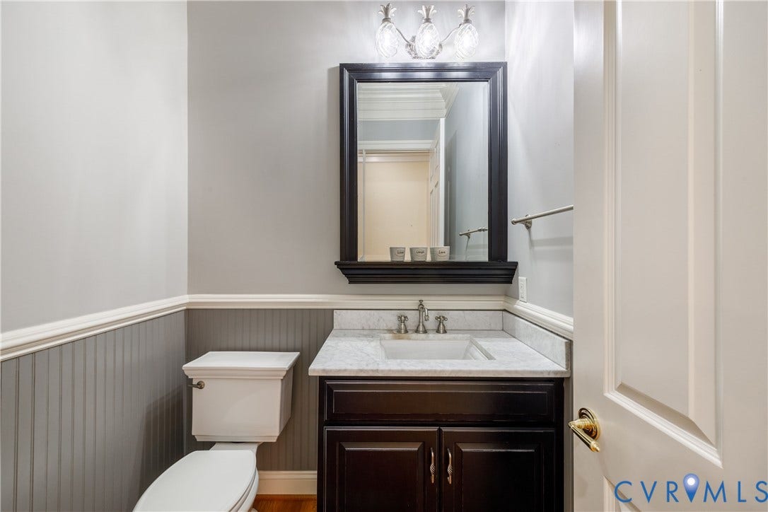 628 Cedar Run Road, Hermitage Country Club Area, Manakin Sabot, VA 23103 Handsome powder room just off the rear hallway features chair rail moulding with wainscoting below.