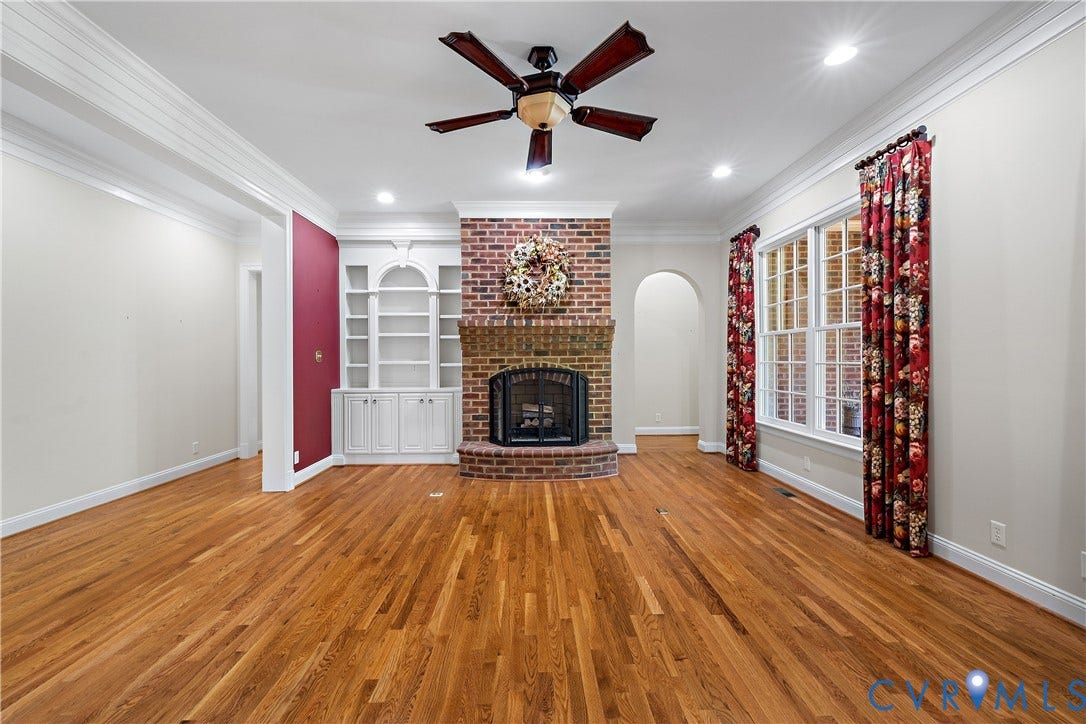 628 Cedar Run Road, Hermitage Country Club Area, Manakin Sabot, VA 23103 To the right of the fireplace is the arched entrance to the primary bedroom suite.