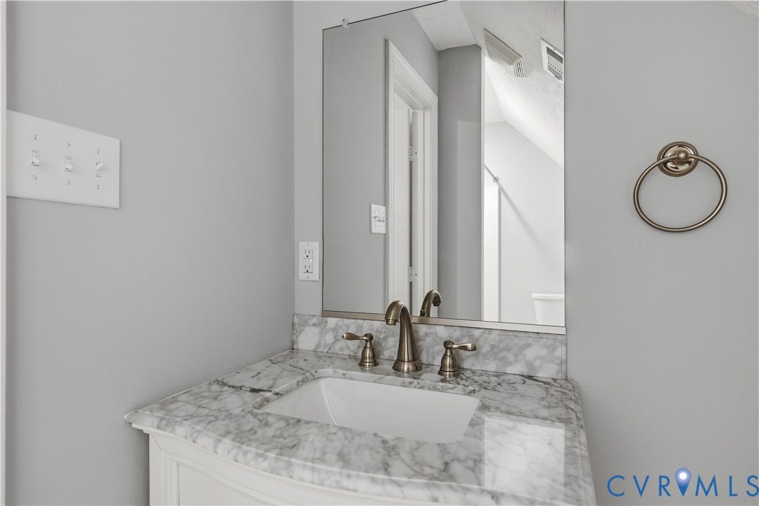 Vanity with a marble-look countertop and integral sink