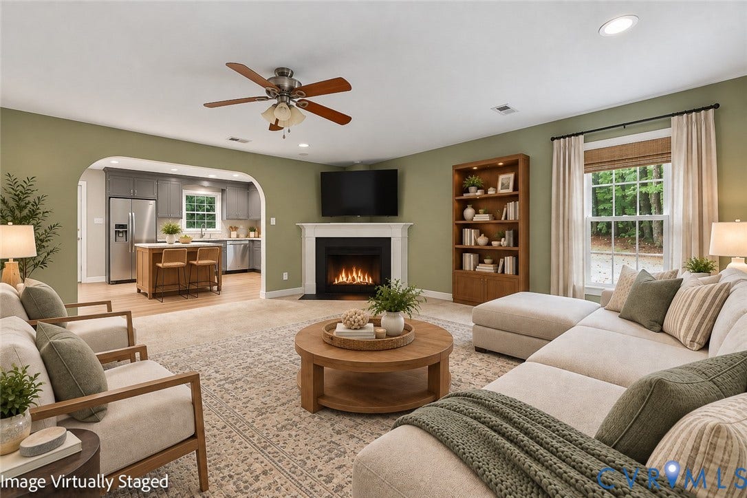 Living space featuring a fireplace with a white mantel, ceiling fan, and recessed lighting