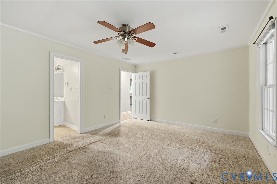 Neutral painted walls with crown molding, carpeted flooring, a ceiling fan with integrated lighting, and a white-framed window