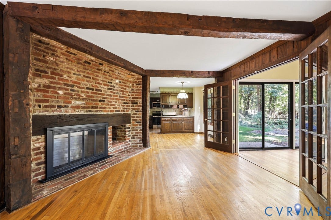 2725 Queenswood Road, Salisbury, Midlothian, VA 23113 Sensational brick wall surrounding fireplace which opens to bright sunroom.