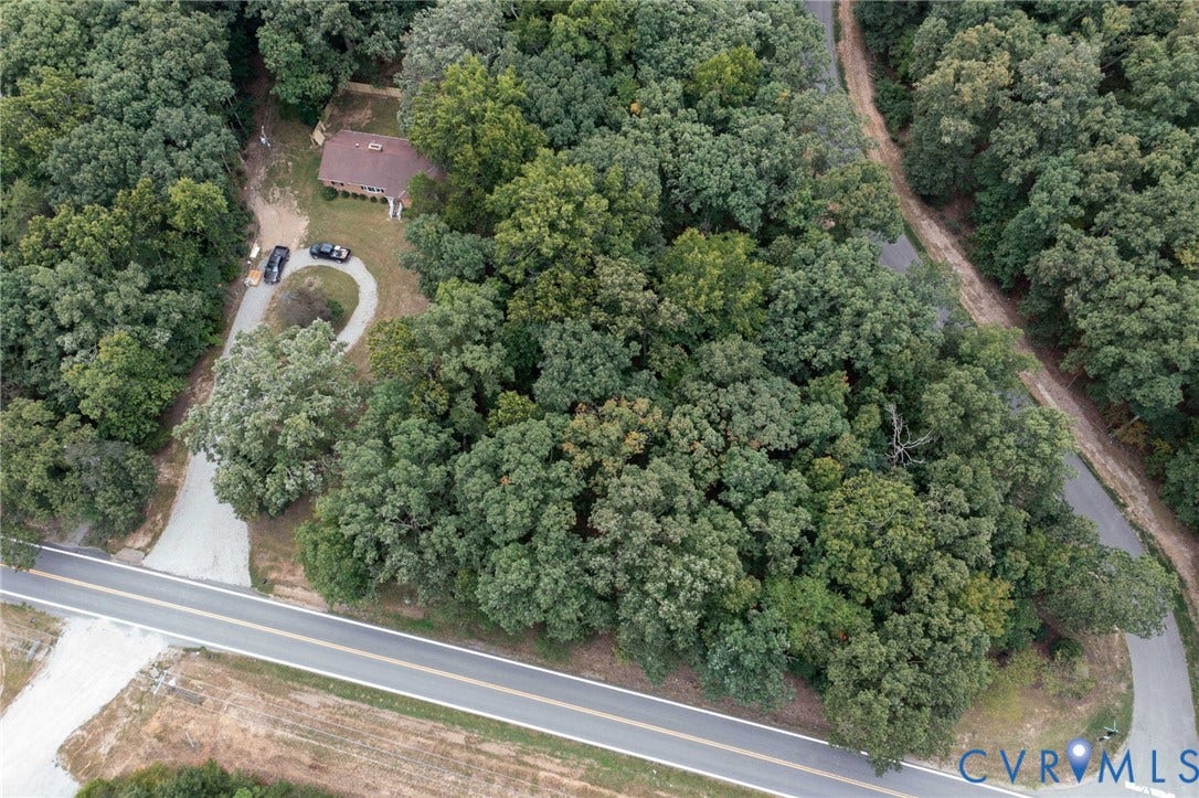 0 Taurman park Drive, Taurman Park, Powhatan, VA 23139 Wooded lot featuring a brown-roofed residence, a paved circular driveway, and direct road access