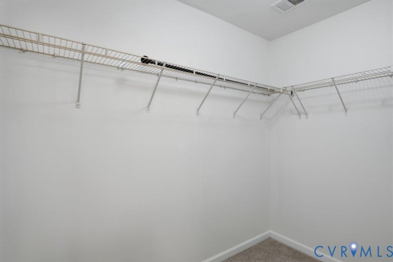 6012 Regal Crest Drive, Kings Grove, Chesterfield, VA 23832 Wall-mounted wire shelving system, integrated hanging rod, light gray carpet, and white painted walls