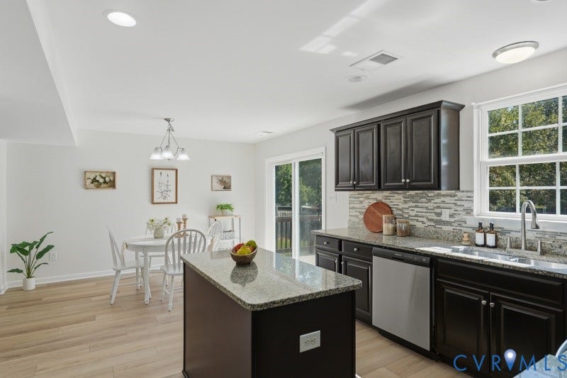 6012 Regal Crest Drive, Kings Grove, Chesterfield, VA 23832 Kitchen featuring dark wood cabinetry, stainless steel dishwasher, an island with a light-colored countertop, and a tile backsplash