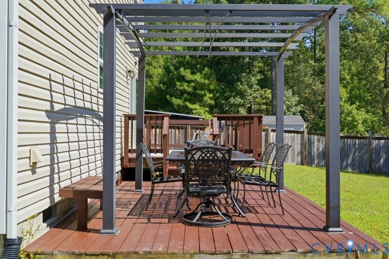 6012 Regal Crest Drive, Kings Grove, Chesterfield, VA 23832 Expansive wood-finish deck featuring a built-in pergola and direct access to the exterior via a wooden staircase