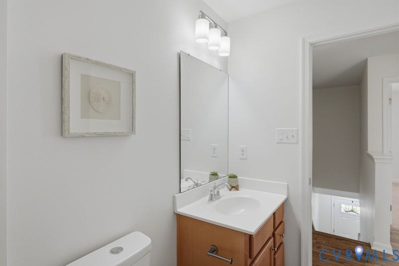 6012 Regal Crest Drive, Kings Grove, Chesterfield, VA 23832 Vanity with integrated sink, chrome faucet, and wood-finish cabinetry