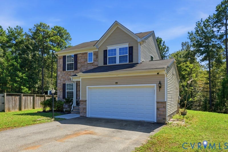 6012 Regal Crest Drive, Kings Grove, Chesterfield, VA 23832 Stone facade accents, siding exterior, attached two-car garage, paved driveway, and a wood privacy fence