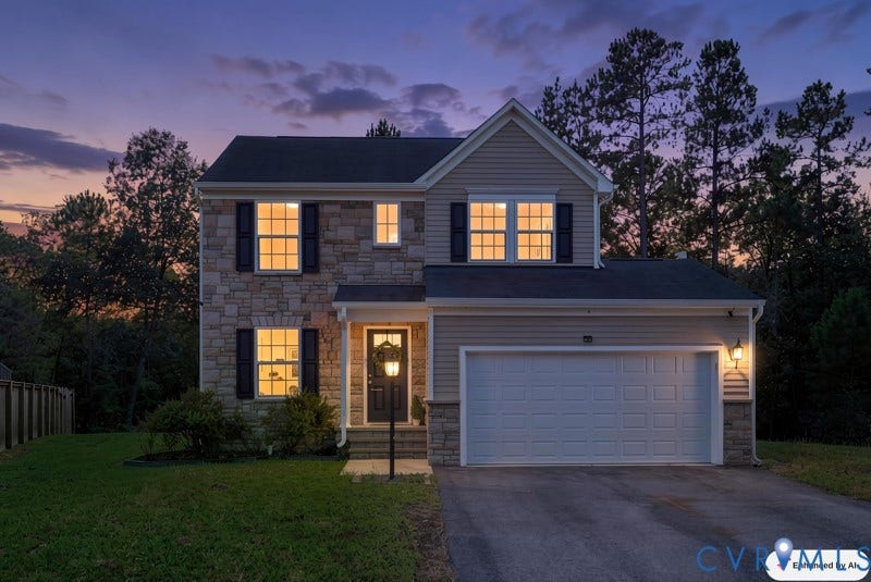 6012 Regal Crest Drive, Kings Grove, Chesterfield, VA 23832 Two-story exterior with stone and siding accents, featuring a prominent two-car garage, multiple windows with black shutters, and a covered entry with a decorative lamp post