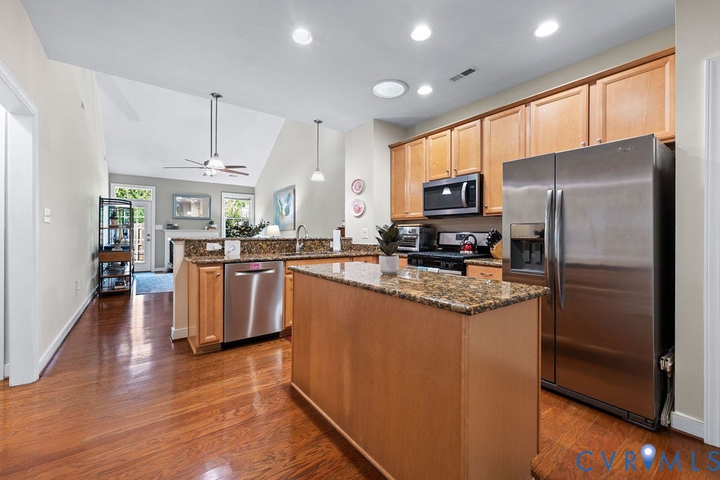 with granite countertops, gas cooking, and stainless steel appliance's