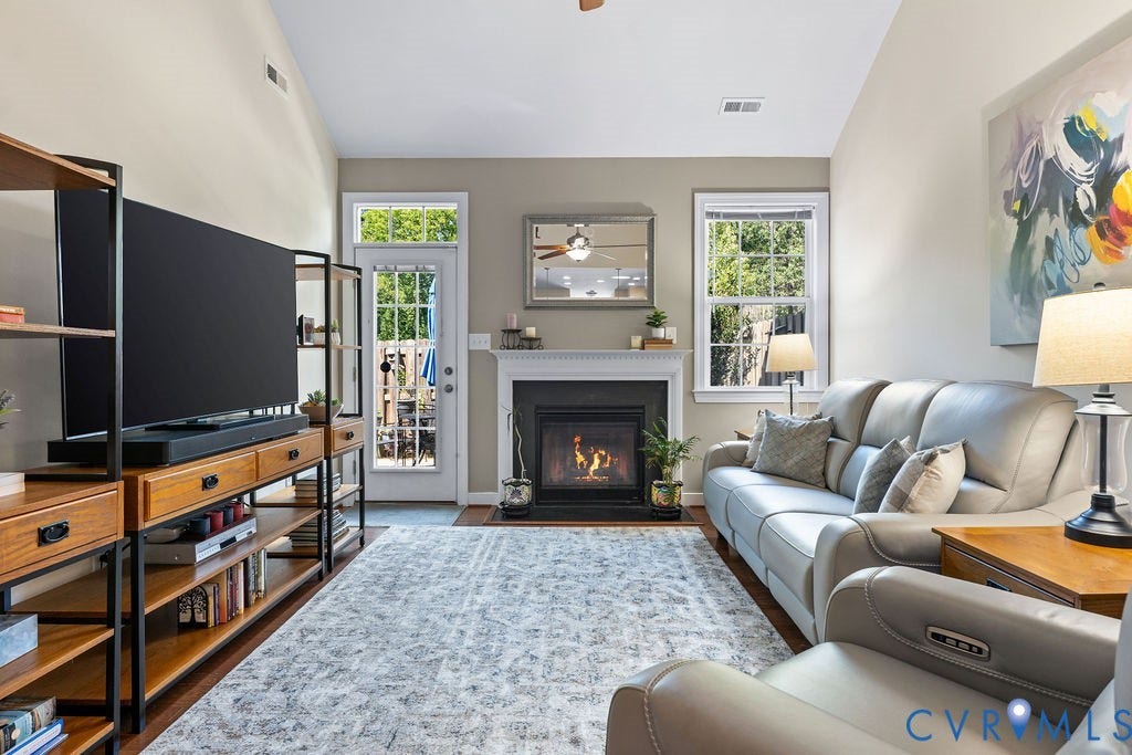 with hard wood floors, vaulted ceiling and fireplace