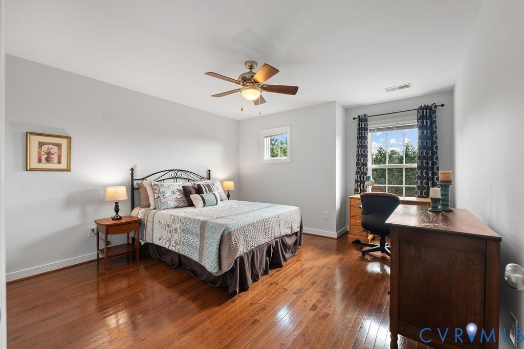 Bedroom with desk nook and hardwood floors