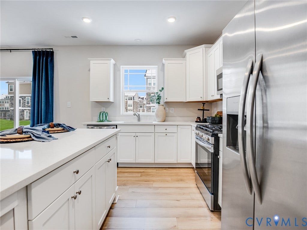 3724 Larimar Lane, Everstone, Richmond, VA 23223 Kitchen featuring white cabinetry, light countertops, stainless steel appliances, wood-finish flooring, and recessed lighting