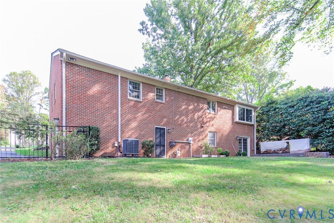 10309 Collinwood Drive, Henrico, VA 23238 Rear view of fenced in backyard with new HVAC unit in 2026