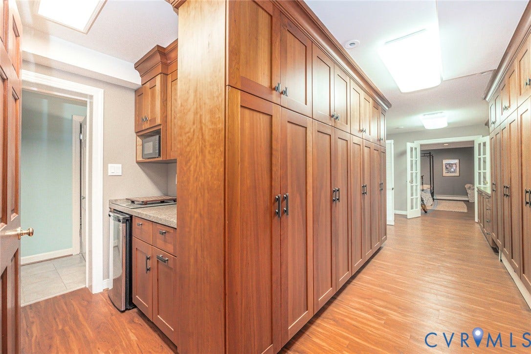 10309 Collinwood Drive, Henrico, VA 23238 View of built in cabinets and dry bar with mini-fridge in Basement