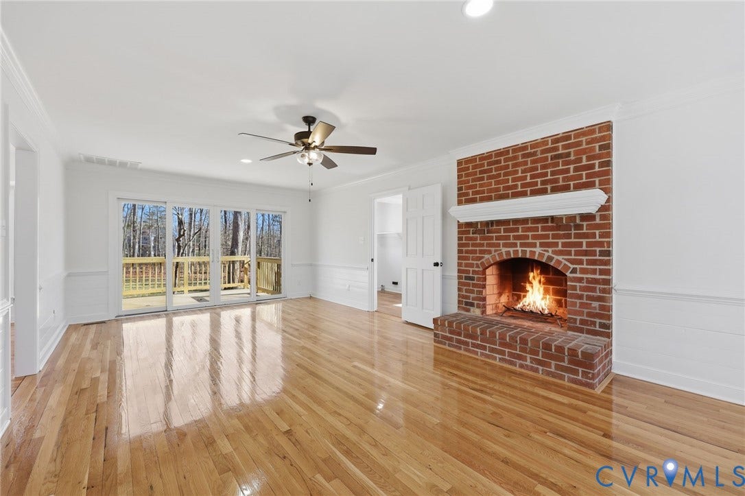 3264 Sherwood Ridge Way, Powhatan, VA 23139 Hardwood flooring, brick fireplace with mantel, white wainscoting, ceiling fan, and sliding glass doors