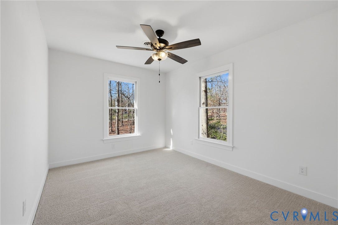 3264 Sherwood Ridge Way, Powhatan, VA 23139 Spacious bedroom with neutral carpeting, triple-panel closet doors, and ceiling fan with integrated lighting