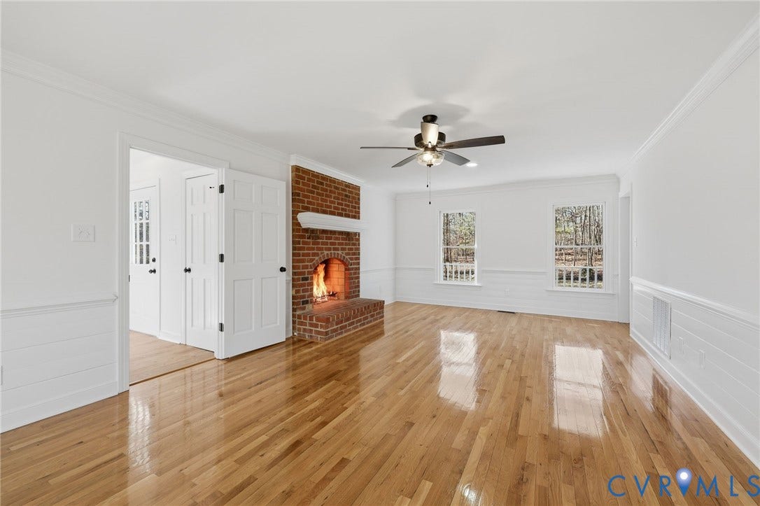 3264 Sherwood Ridge Way, Powhatan, VA 23139 Brick fireplace with hearth and mantel, wood-finish flooring, ceiling fan with light fixture, and two double-hung windows