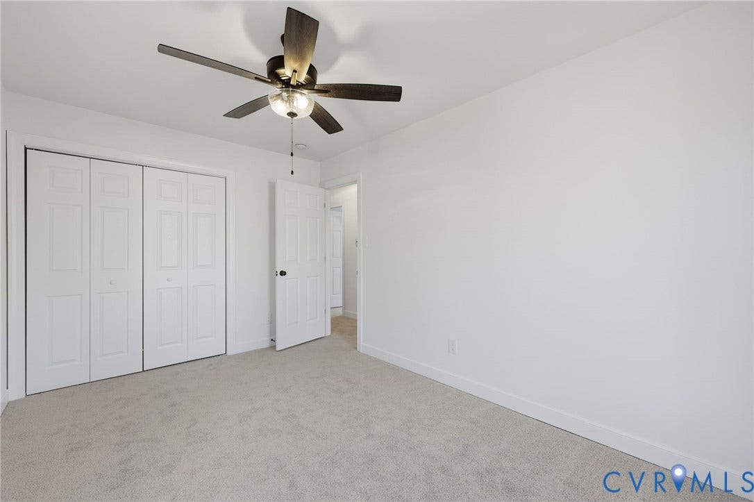 3264 Sherwood Ridge Way, Powhatan, VA 23139 Neutral carpet flooring, two windows, ceiling fan with integrated lighting, and white wall finishes