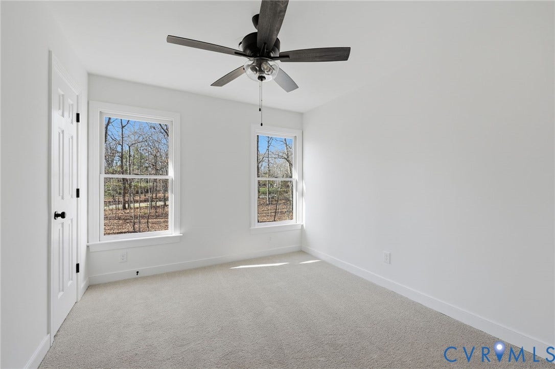 3264 Sherwood Ridge Way, Powhatan, VA 23139 Neutral paint palette, two large windows, ceiling fan, and light gray carpeting