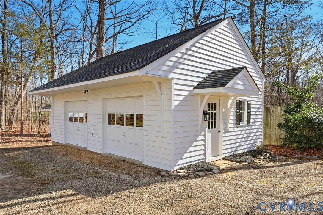 3264 Sherwood Ridge Way, Powhatan, VA 23139 White-painted storage shed with a gabled roof and double doors