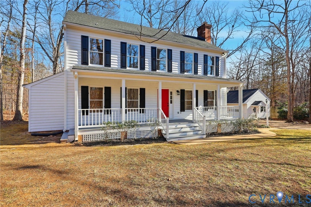 3264 Sherwood Ridge Way, Powhatan, VA 23139 Traditional colonial exterior with white siding and a covered front porch, featuring dark shutters and a vibrant red entry door