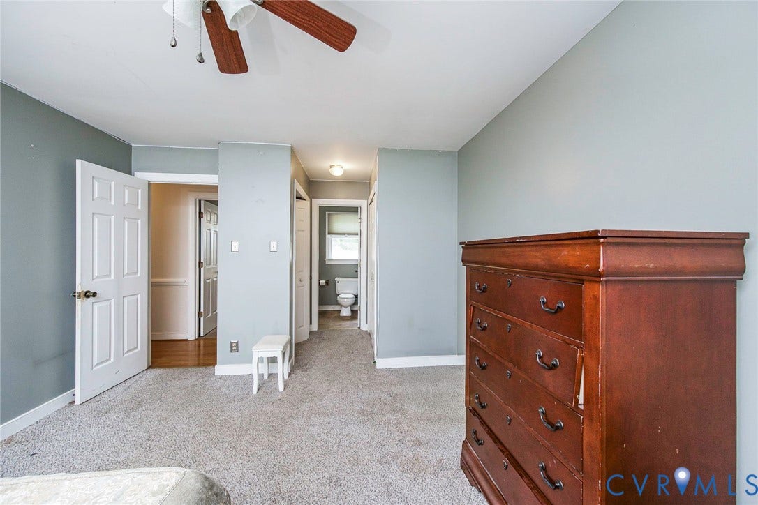 Carpeted flooring, ceiling fan, and painted walls