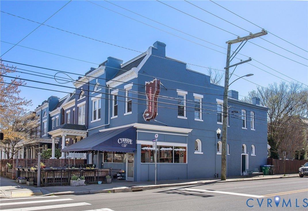 Commercial property featuring a corner location, multiple windows, an awning, and a prominent street-facing entrance