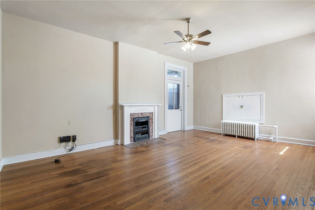 2604 Grove, #5, Richmond, VA 23220 Hardwood flooring throughout, decorative fireplace with tile surround, ceiling fan, and white trim