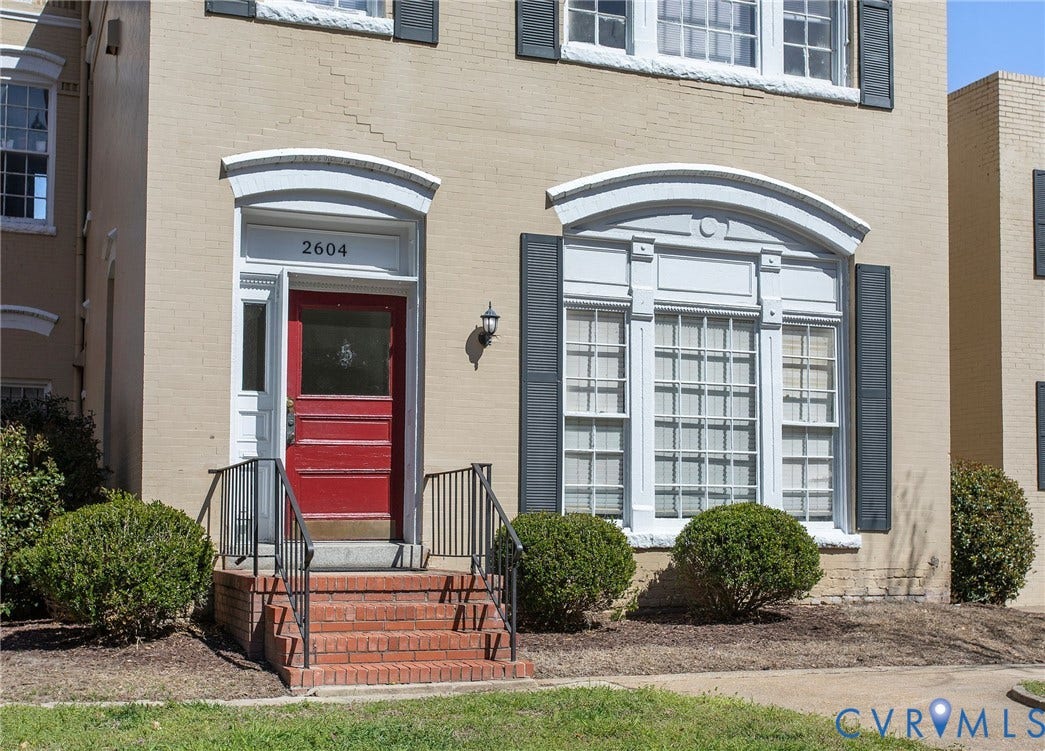 2604 Grove, #5, Richmond, VA 23220 Brick exterior with decorative window trim, a red front door, and a brick entry stoop with metal railings
