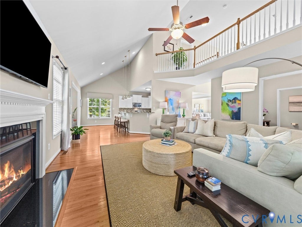 1663 Centerville Parke Lane, The Parke At Centerville, Manakin Sabot, VA 23103 Vaulted ceiling featuring a ceiling fan, fireplace with a white mantel, hardwood flooring, and an open concept layout