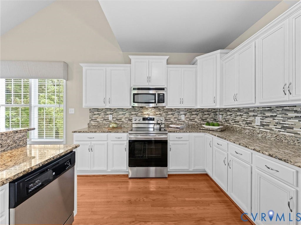 1663 Centerville Parke Lane, The Parke At Centerville, Manakin Sabot, VA 23103 Kitchen featuring white cabinetry, granite countertops, tile backsplash, stainless steel appliances, and wood-finish flooring