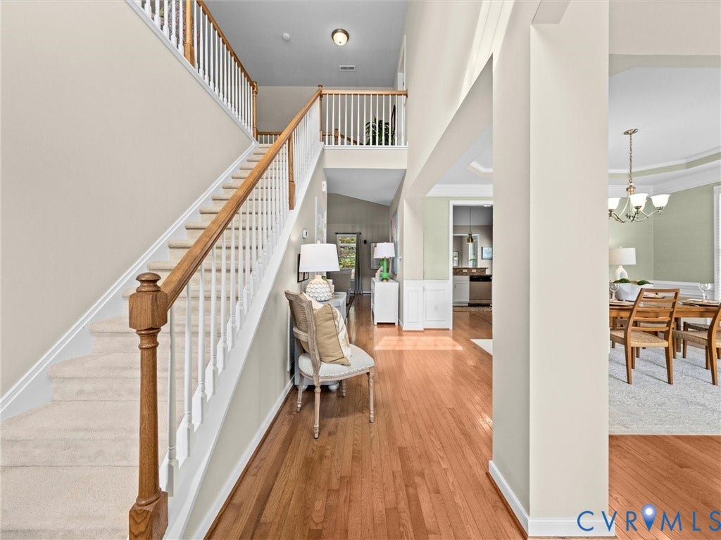 1663 Centerville Parke Lane, The Parke At Centerville, Manakin Sabot, VA 23103 Two-story foyer with hardwood flooring, carpeted staircase with wood handrail, and white balusters