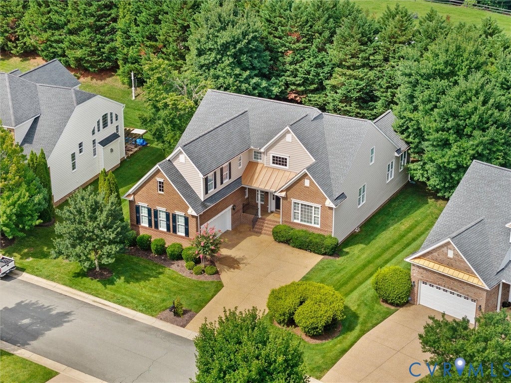 1663 Centerville Parke Lane, The Parke At Centerville, Manakin Sabot, VA 23103 Traditional-style residence featuring a brick and siding exterior, gray shingle roof, and a prominent front-facing garage