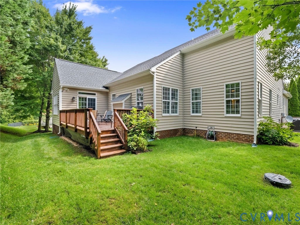 1663 Centerville Parke Lane, The Parke At Centerville, Manakin Sabot, VA 23103 Exterior featuring light-colored siding, a wooden deck with railing, a shingled roof, a green lawn, and mature trees