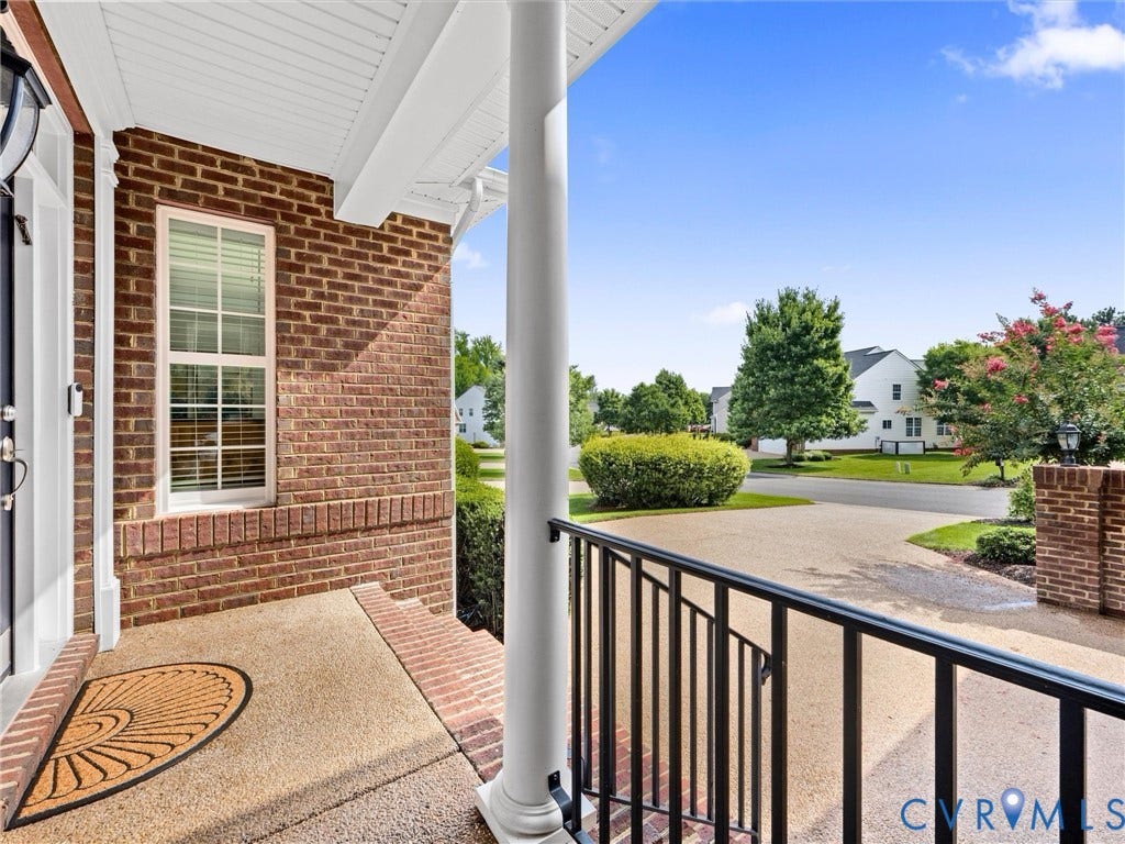 1663 Centerville Parke Lane, The Parke At Centerville, Manakin Sabot, VA 23103 Brick exterior with white trim, covered front porch, and black metal railing