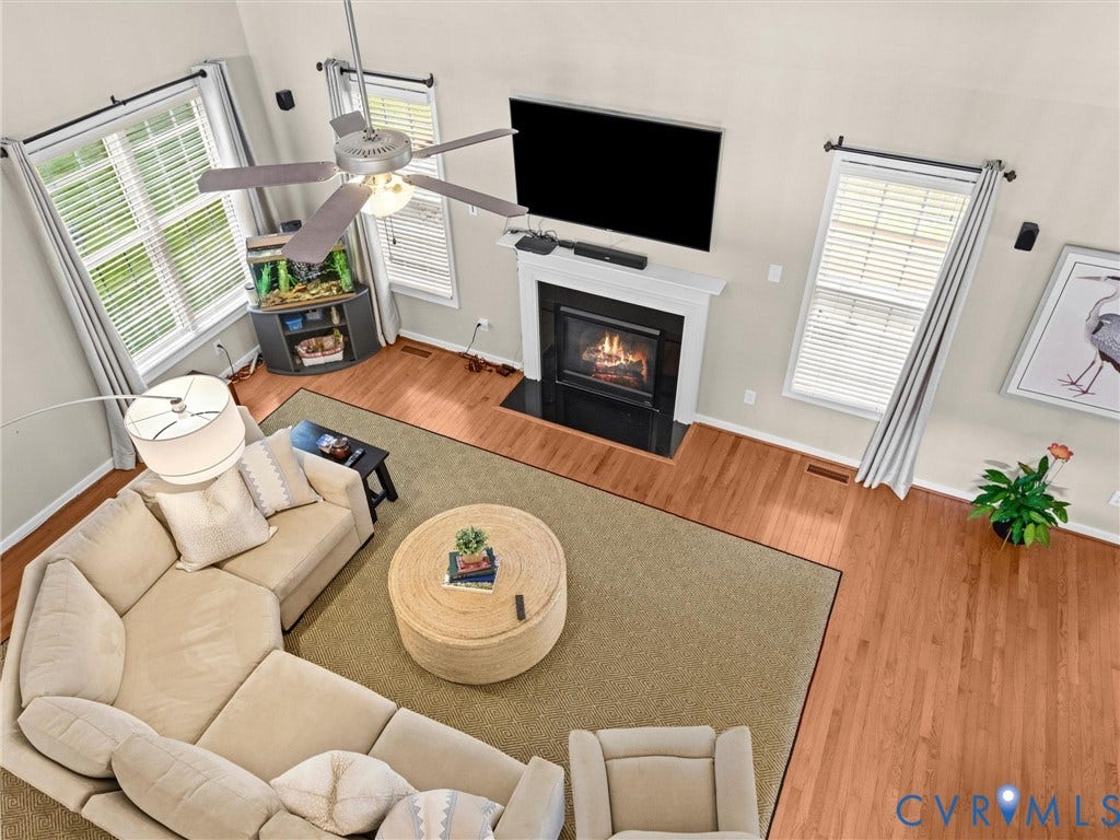 1663 Centerville Parke Lane, The Parke At Centerville, Manakin Sabot, VA 23103 Vaulted ceilings, a built-in fireplace with a white mantel, hardwood flooring, and multiple windows with blinds