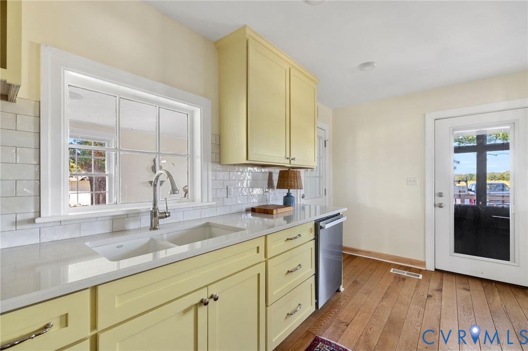 4109 Whitehall Road, Sandy Hook, VA 23153 Kitchen featuring wood-finish flooring, light yellow cabinetry, undermount double-basin sink, stainless steel dishwasher, and white subway tile backsplash