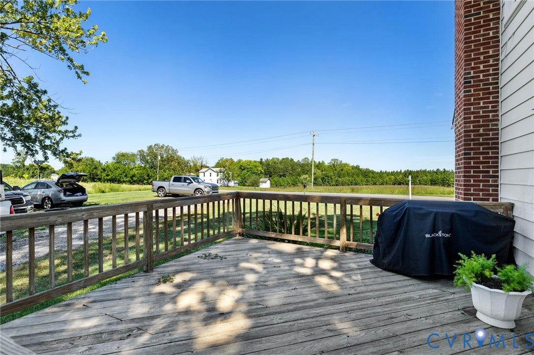 4109 Whitehall Road, Sandy Hook, VA 23153 Outdoor wooden deck with railing, siding exterior, and a brick chimney structure