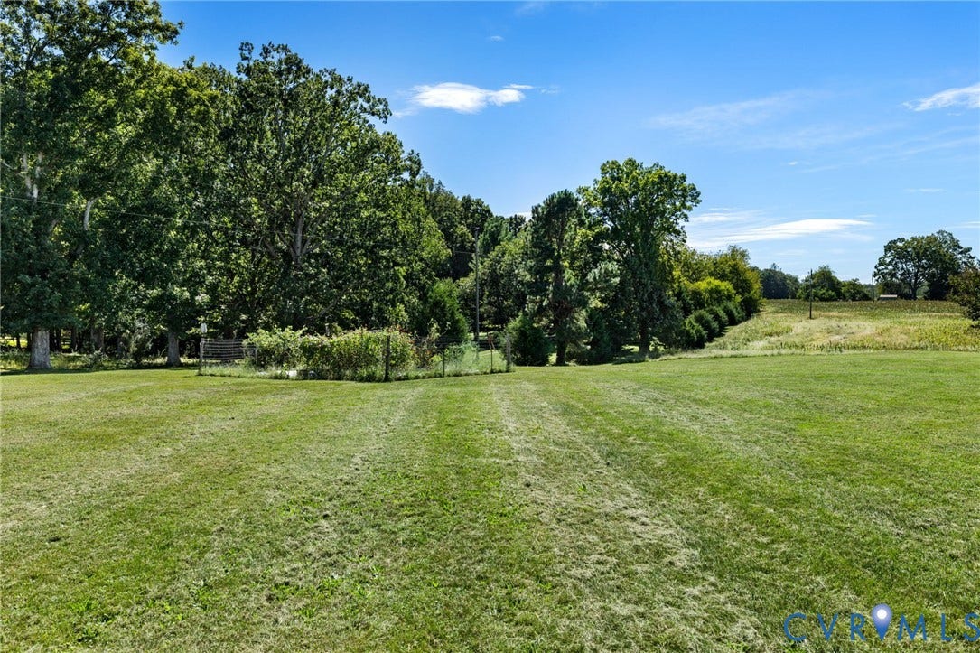 4109 Whitehall Road, Sandy Hook, VA 23153 Expansive green lawn with a tree-lined border and distant fields