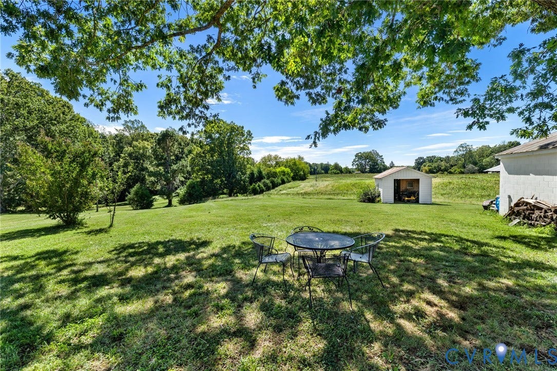 4109 Whitehall Road, Sandy Hook, VA 23153 Expansive green lawn with mature trees and a detached shed