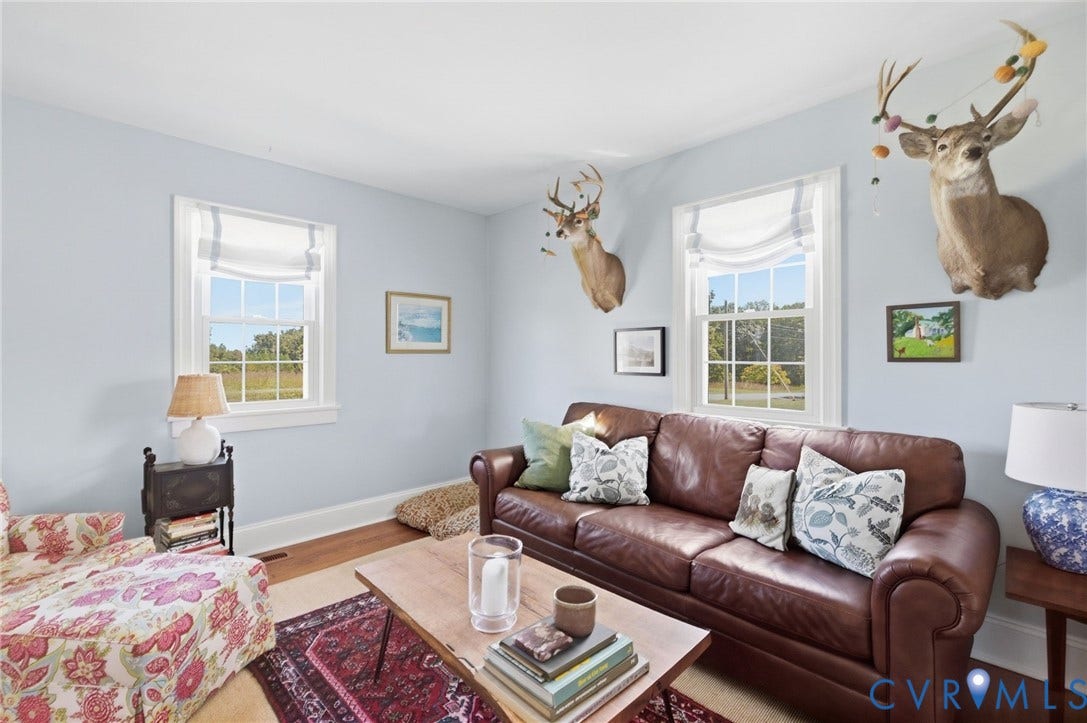 4109 Whitehall Road, Sandy Hook, VA 23153 Light blue wall finish complemented by classic white trim, warm wood-finish flooring, and white window treatments