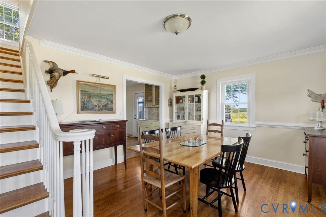 4109 Whitehall Road, Sandy Hook, VA 23153 Hardwood flooring throughout, white painted staircase with wood treads, crown molding, chair rail molding, and a built-in display cabinet
