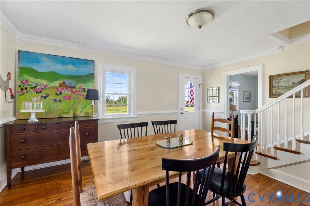 4109 Whitehall Road, Sandy Hook, VA 23153 Hardwood flooring, white crown molding, a built-in staircase with white risers, and a window with natural light